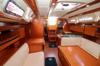 Interior of 2007 Dufour 40 Performance yacht, featuring wood finish and cozy seating area.