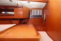 Interior of 2007 Dufour 40 Performance yacht with navigation panel and wooden cabinetry.