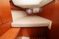 Cozy cabin interior of 2007 Dufour 40 Performance yacht with wooden finish.