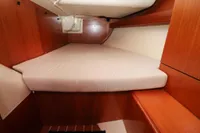Cabin interior of 2007 Dufour 40 Performance yacht with wooden finish and bed.