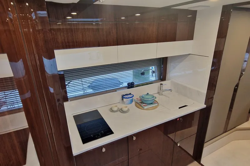 Volvo Ips & Dps Yacht Photos Pics Luxurious kitchen interior of 2024 Fairline Targa 45 Open yacht, featuring modern appliances.