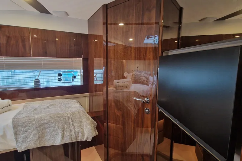 Volvo Ips & Dps Yacht Photos Pics 2024 Fairline Targa 45 Open interior with wood finish, bed, and TV.