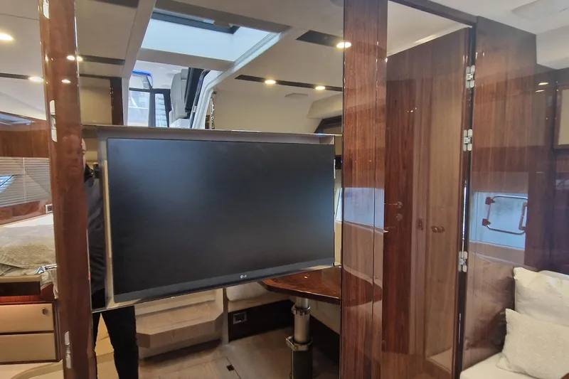 Volvo Ips & Dps Yacht Photos Pics Interior of 2024 Fairline Targa 45 Open yacht with modern TV and luxurious wood finish.