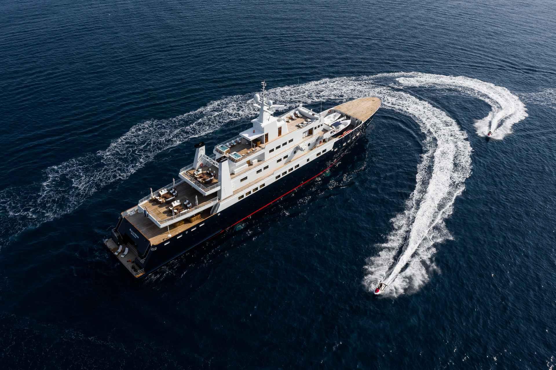 Aerial view of a luxury yacht with a jet ski, 1980 Custom Conversion model.