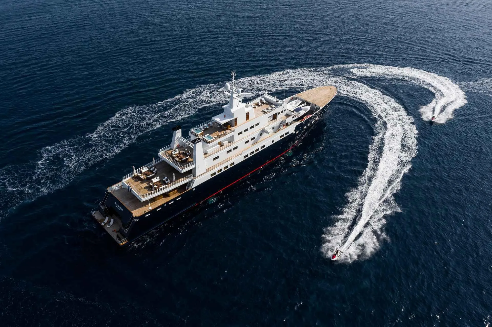 Aerial view of a luxury yacht with a jet ski, 1980 Custom Conversion model.