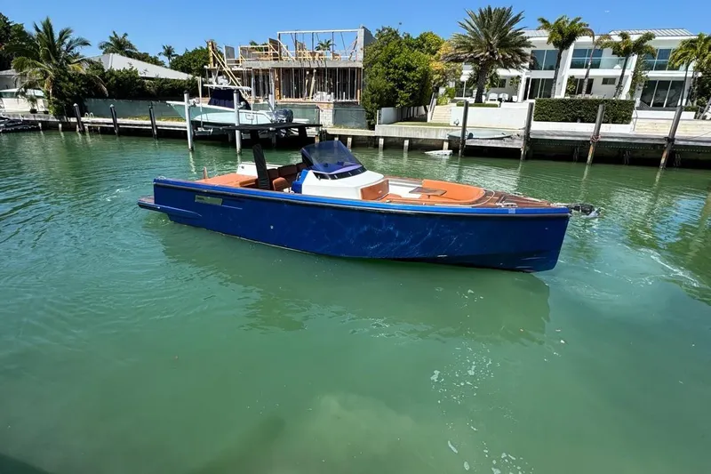  Yacht Photos Pics 2017 Fjord 36' Open boat in a serene marina setting.