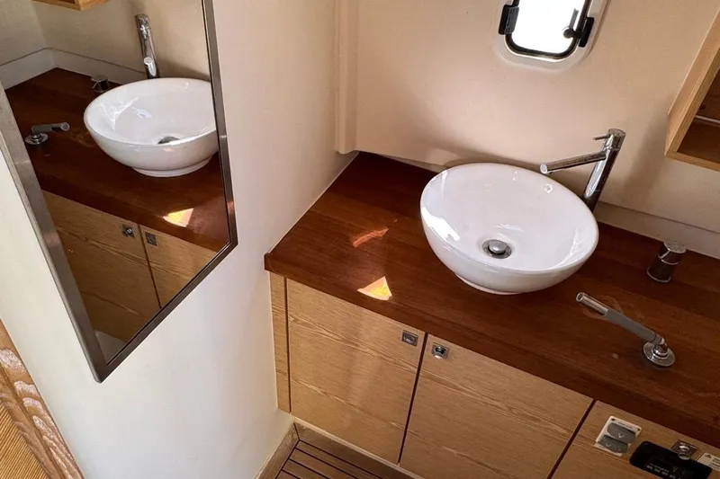 Yacht Photos Pics Modern bathroom in 2017 Fjord 36' Open yacht with wooden countertop and vessel sink.