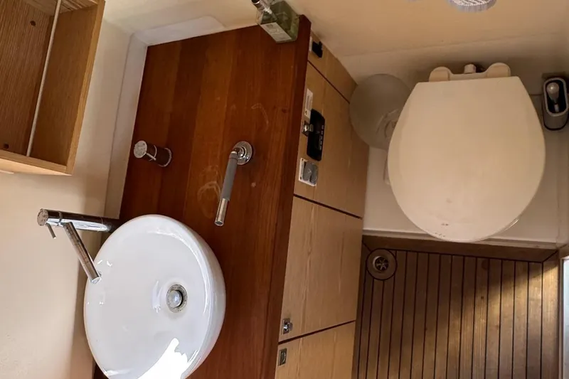  Yacht Photos Pics 2017 Fjord 36' Open yacht bathroom with wooden cabinetry and modern fixtures.