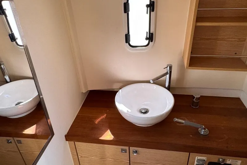  Yacht Photos Pics Modern bathroom interior on 2017 Fjord 36' Open yacht with sleek sink and wooden countertop.