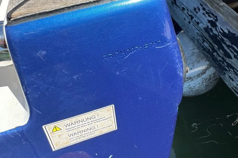  Yacht Photos Pics Close-up of a blue 2017 Fjord 36' Open boat with warning label.