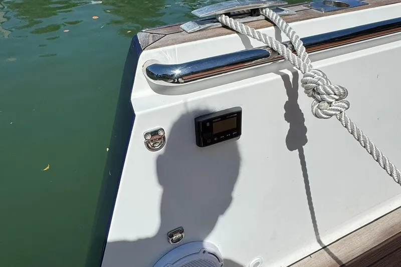  Yacht Photos Pics 2017 Fjord 36' Open boat with rope and control panel by the water.