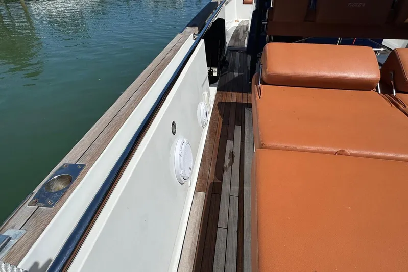  Yacht Photos Pics 2017 Fjord 36' Open boat with teak deck and orange seating.