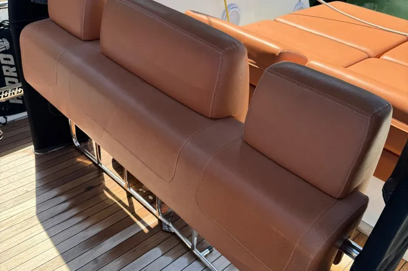  Yacht Photos Pics Brown leather seating on 2017 Fjord 36' Open boat, with wooden deck.