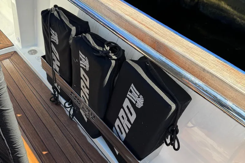  Yacht Photos Pics Black fenders on a 2017 Fjord 36' Open boat with wooden deck.