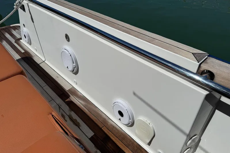  Yacht Photos Pics 2017 Fjord 36' Open boat deck with speakers and seating, docked on calm water.