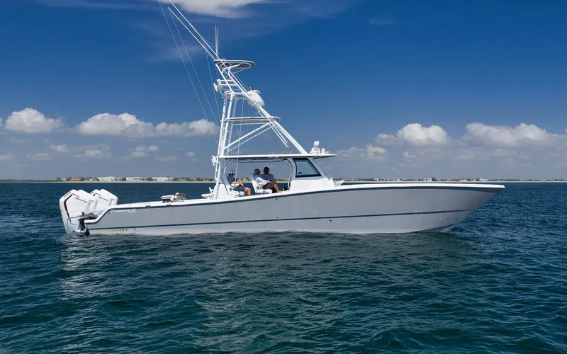  Yacht Photos Pics 2022 Freeman 47 boat cruising on open water under a clear blue sky.