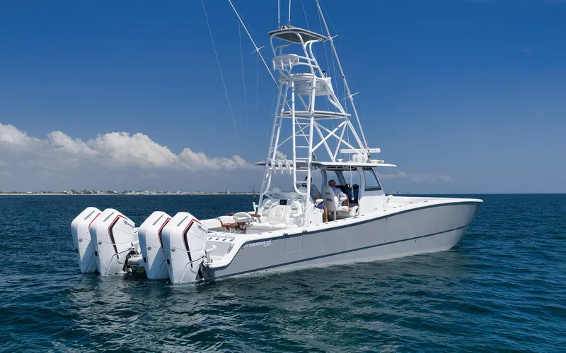  Yacht Photos Pics 2022 Freeman 47 boat with four engines on open water under clear blue sky.