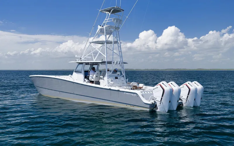  Yacht Photos Pics 2022 Freeman 47 boat on open water with clear skies and four engines.