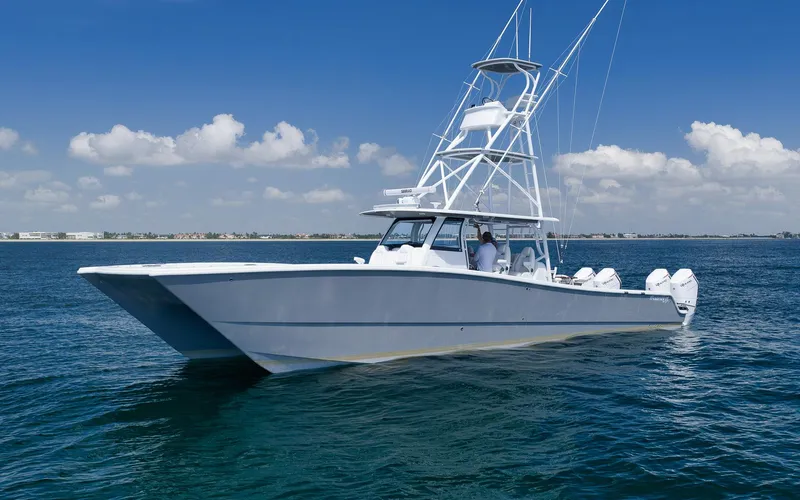  Yacht Photos Pics 2022 Freeman 47 boat on calm blue water under clear sky.