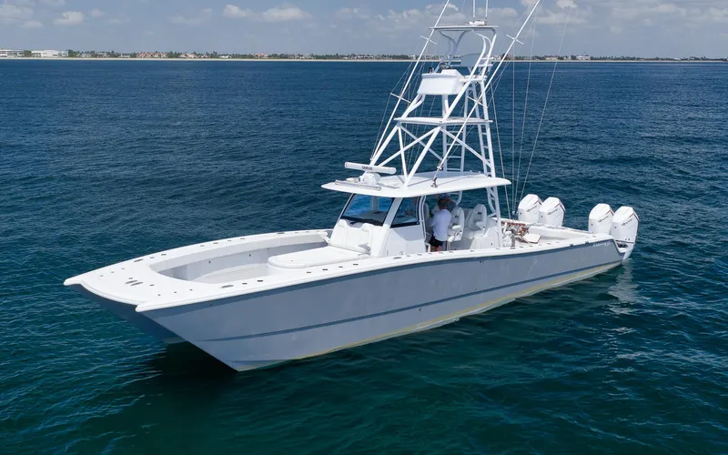  Yacht Photos Pics 2022 Freeman 47 boat on open water, featuring multiple outboard engines and a sleek design.