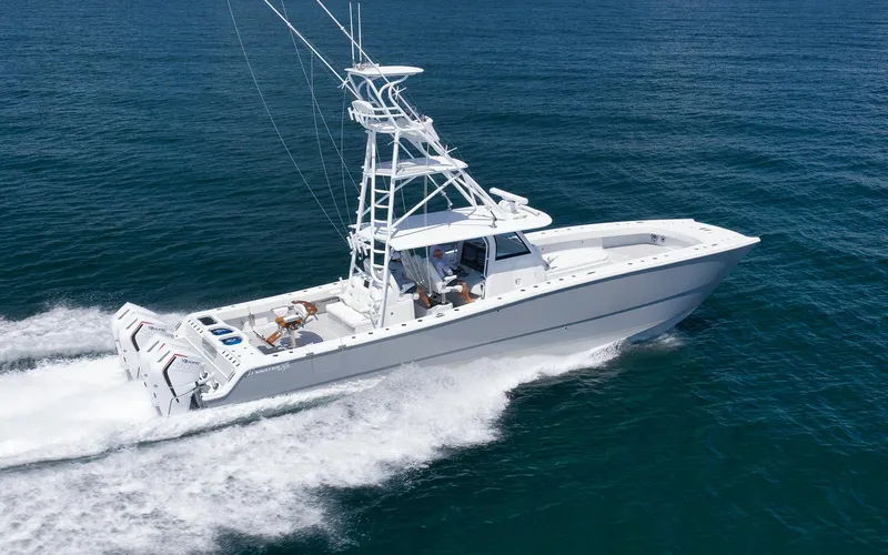  Yacht Photos Pics 2022 Freeman 47 boat cruising on open water, showcasing sleek design and powerful engines.