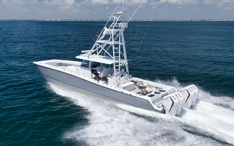  Yacht Photos Pics 2022 Freeman 47 boat cruising on open water with multiple outboard engines.