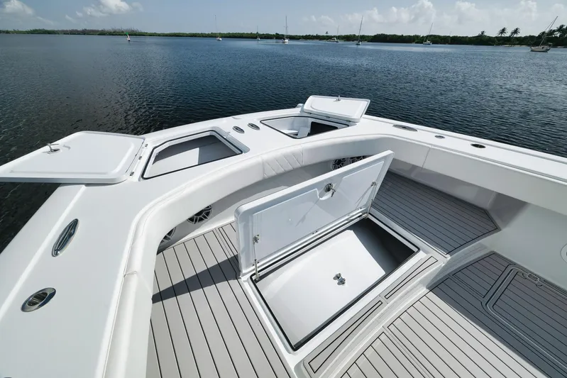  Yacht Photos Pics Freeman 47 boat deck with open storage compartments, 2022 model, on calm water.