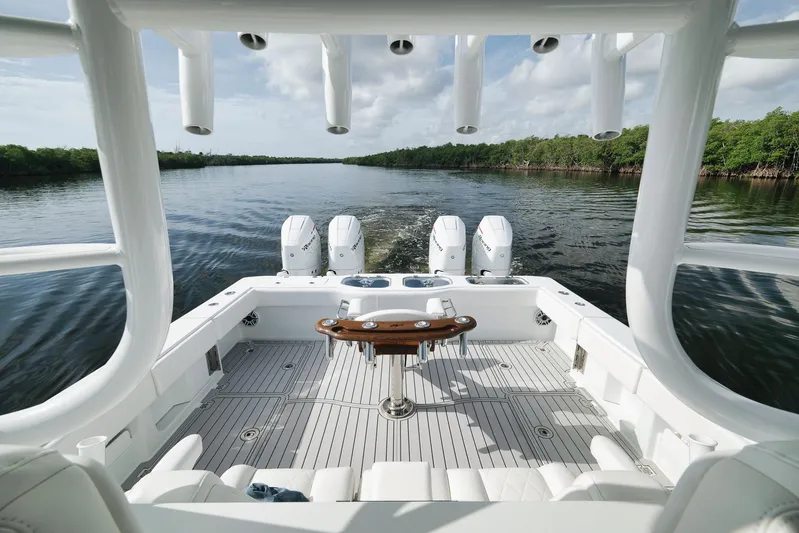  Yacht Photos Pics Freeman 47 boat, 2022 model, cruising on a calm river with lush greenery.