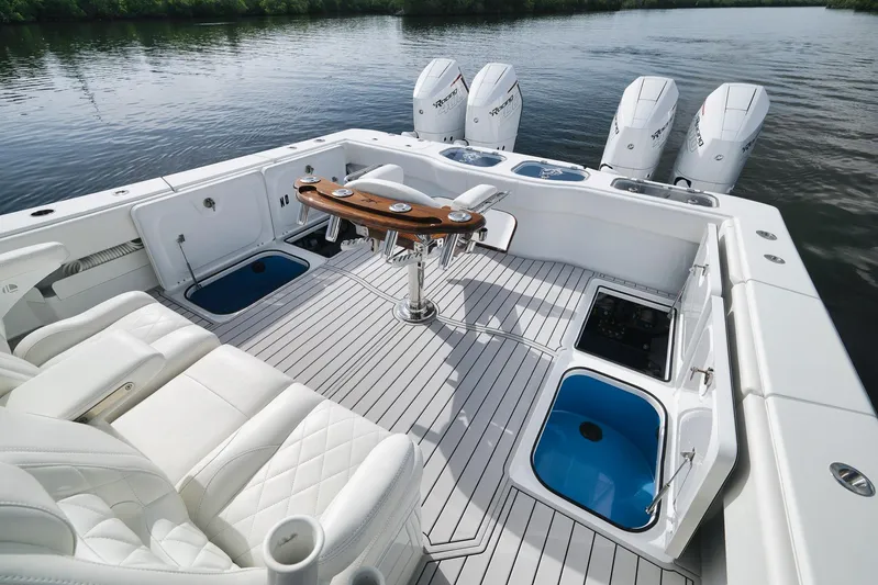  Yacht Photos Pics Luxurious 2022 Freeman 47 boat interior with white seating and multiple outboard engines.