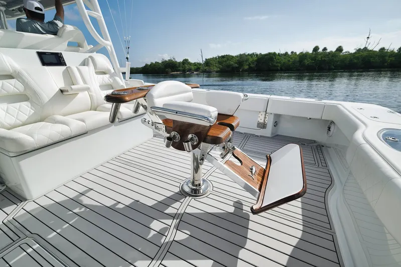  Yacht Photos Pics Luxury seating on a 2022 Freeman 47 boat with elegant wood and white upholstery.