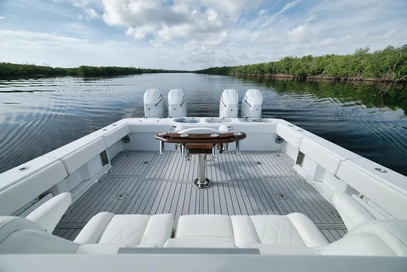  Yacht Photos Pics Freeman 47 boat, 2022 model, with spacious deck and multiple engines on a calm waterway.