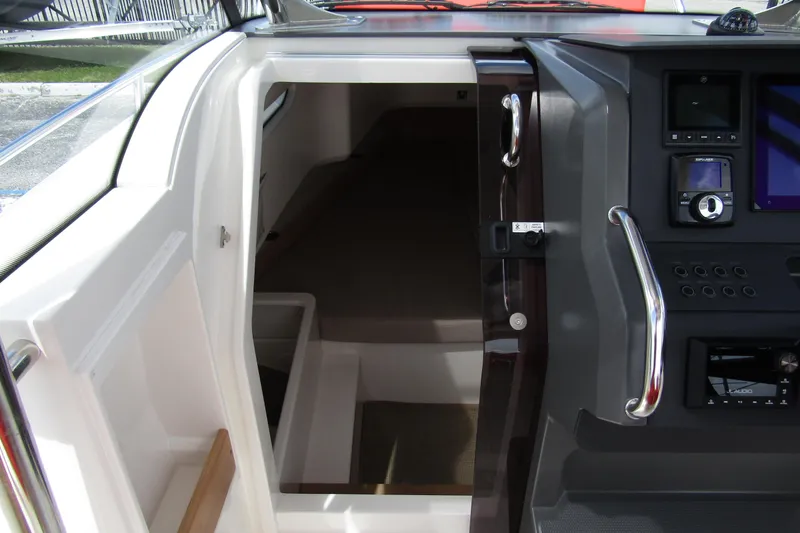  Yacht Photos Pics 2024 Nimbus T8 boat interior with control panel and cabin entrance.