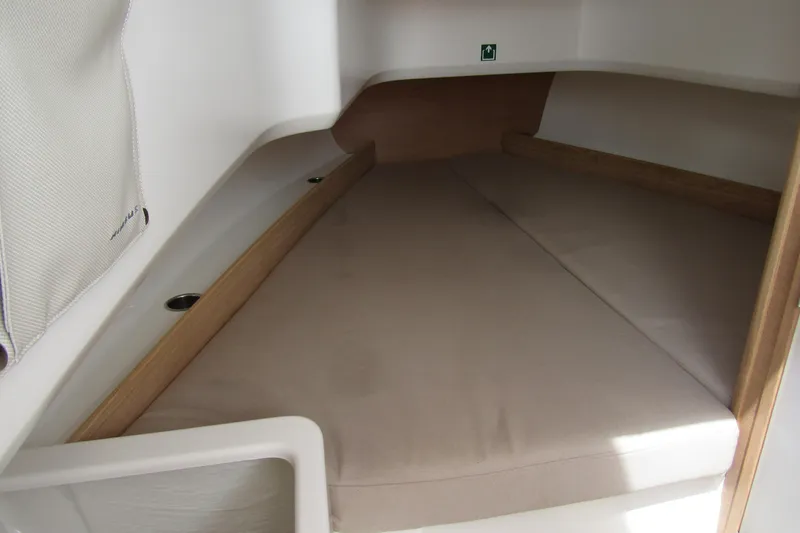  Yacht Photos Pics 2024 Nimbus T8 cabin interior with beige cushions and wooden accents.
