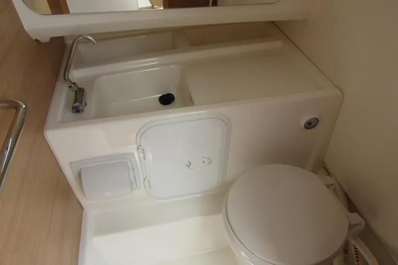  Yacht Photos Pics Compact bathroom in 2024 Nimbus T8 boat with sink and toilet.