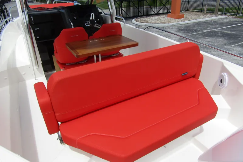  Yacht Photos Pics 2024 Nimbus T8 boat interior with vibrant red seating and wooden table.