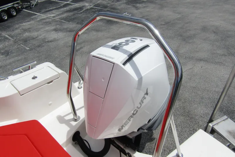  Yacht Photos Pics 2024 Nimbus T8 boat with Mercury outboard engine, featuring red seating and stainless steel railings.