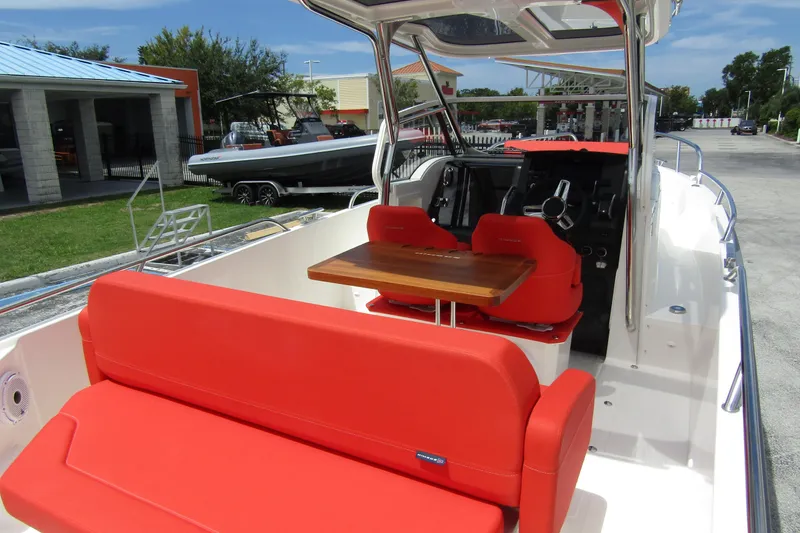  Yacht Photos Pics 2024 Nimbus T8 boat with vibrant red seating and sleek interior design.