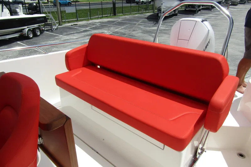  Yacht Photos Pics Red cushioned seating on 2024 Nimbus T8 boat, parked in a lot.