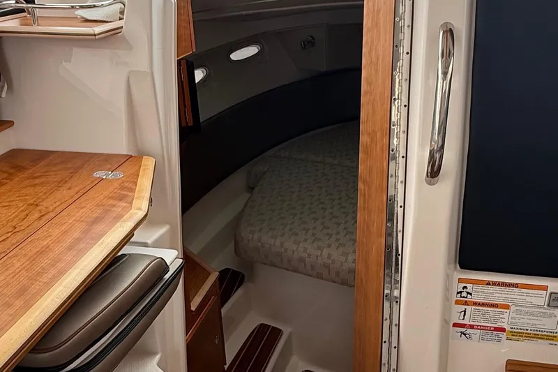  Yacht Photos Pics 2025 Cutwater C-32 CB cabin interior with wooden accents and cozy sleeping area.