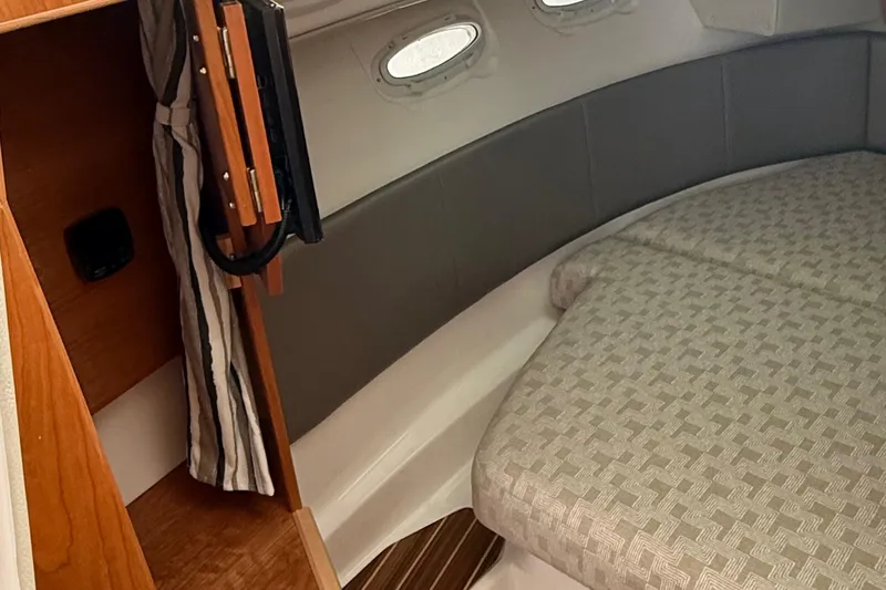  Yacht Photos Pics 2025 Cutwater C-32 CB cabin interior with bed and portholes.