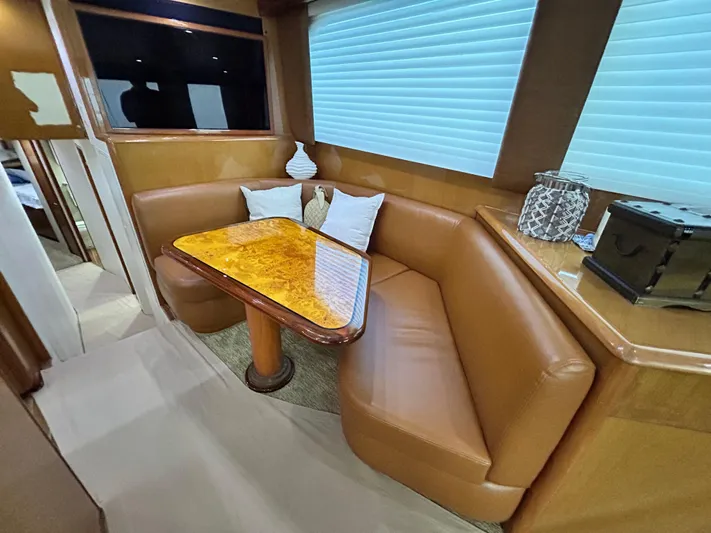 Carisa Yacht Photos Pics Luxurious interior of 2001 Viking 55 Convertible yacht with leather seating and wooden table.