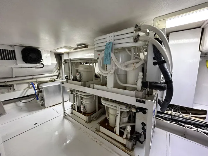 Carisa Yacht Photos Pics Engine room of 2001 Viking 55 Convertible yacht, featuring mechanical equipment and piping.