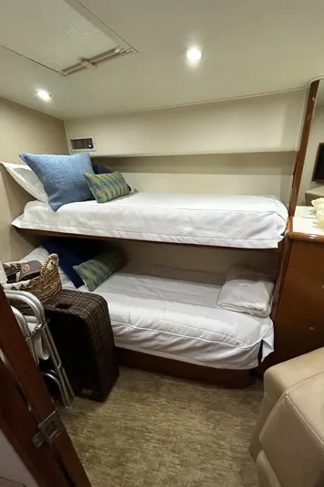 Carisa Yacht Photos Pics Bunk beds in 2001 Viking 55 Convertible yacht cabin, featuring cozy bedding and storage.