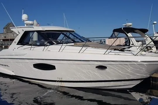 Sea Wolf Yacht Photos Pics 2013 Regal 42 Sport Coupe yacht docked in a marina under clear blue skies.