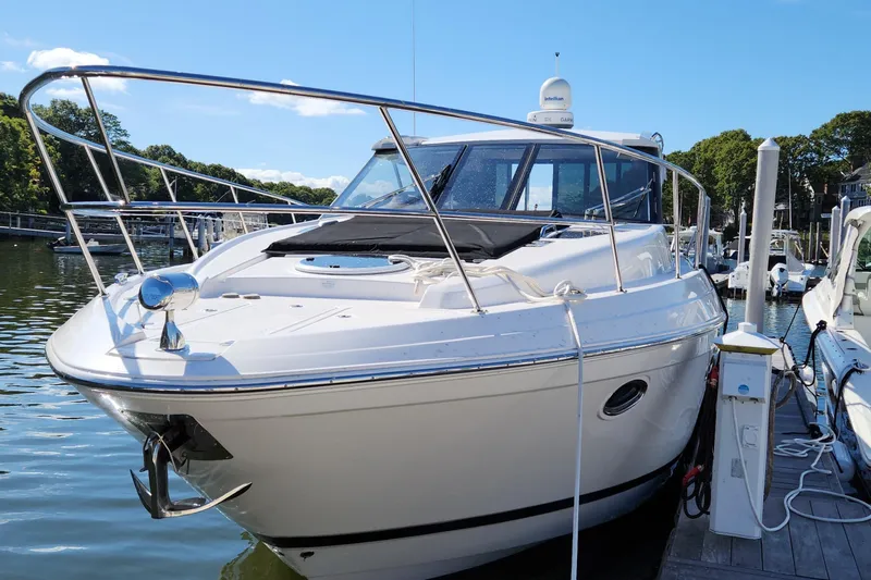 Sea Wolf Yacht Photos Pics 2013 Regal 42 Sport Coupe yacht docked at marina, sunny day, calm waters.