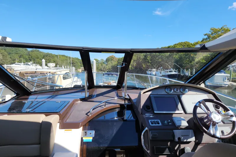 Sea Wolf Yacht Photos Pics Interior view of 2013 Regal 42 Sport Coupe yacht cockpit with navigation equipment.