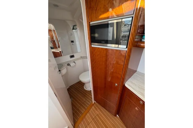  Yacht Photos Pics Interior of 2016 Intrepid 475 Panacea featuring a compact bathroom and microwave.