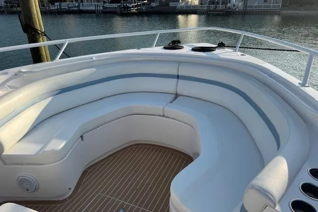  Yacht Photos Pics 2016 Intrepid 475 Panacea boat with spacious white seating area and wooden deck.