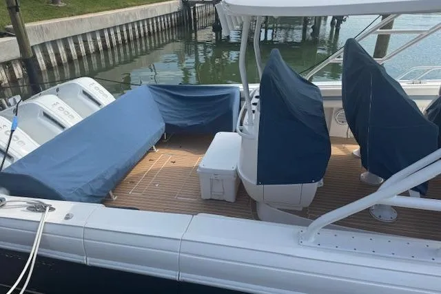  Yacht Photos Pics 2016 Intrepid 475 Panacea boat with covered seating and engines docked by the water.