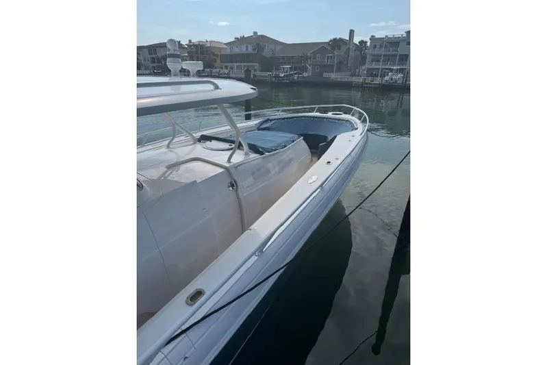  Yacht Photos Pics 2016 Intrepid 475 Panacea boat docked in a serene waterfront setting.